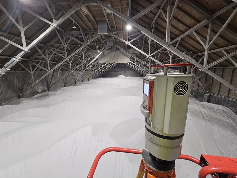 Riegl VZ-1000 laser scanner mounted on a red lift platform above the salt piles for elevated coverage of large warehouse interiors