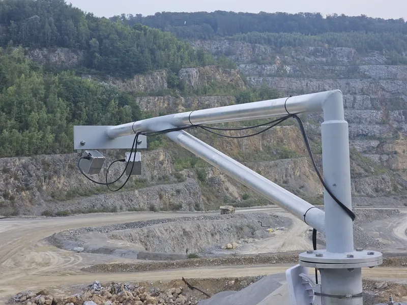 OWL EYE® platform on a cantilevered steel arm above a limestone quarry — Dual-Avia LiDAR for stockpile monitoring in mining operations